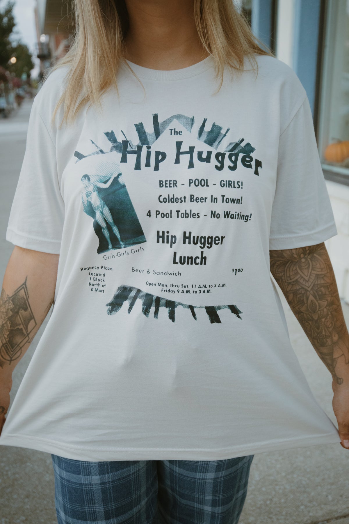 Model wearing The Original Kokomo Hip Hugger Ad graphic tee on a downtown street