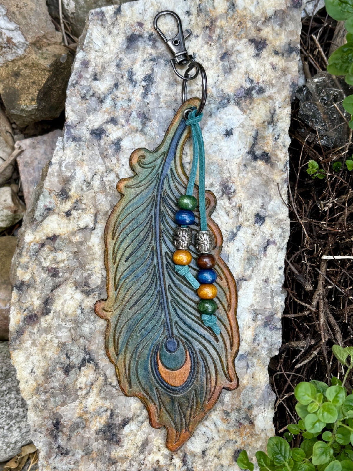 Large hand-tooled leather peacock feather bag charm with wood beads by Angie Meyers Designs