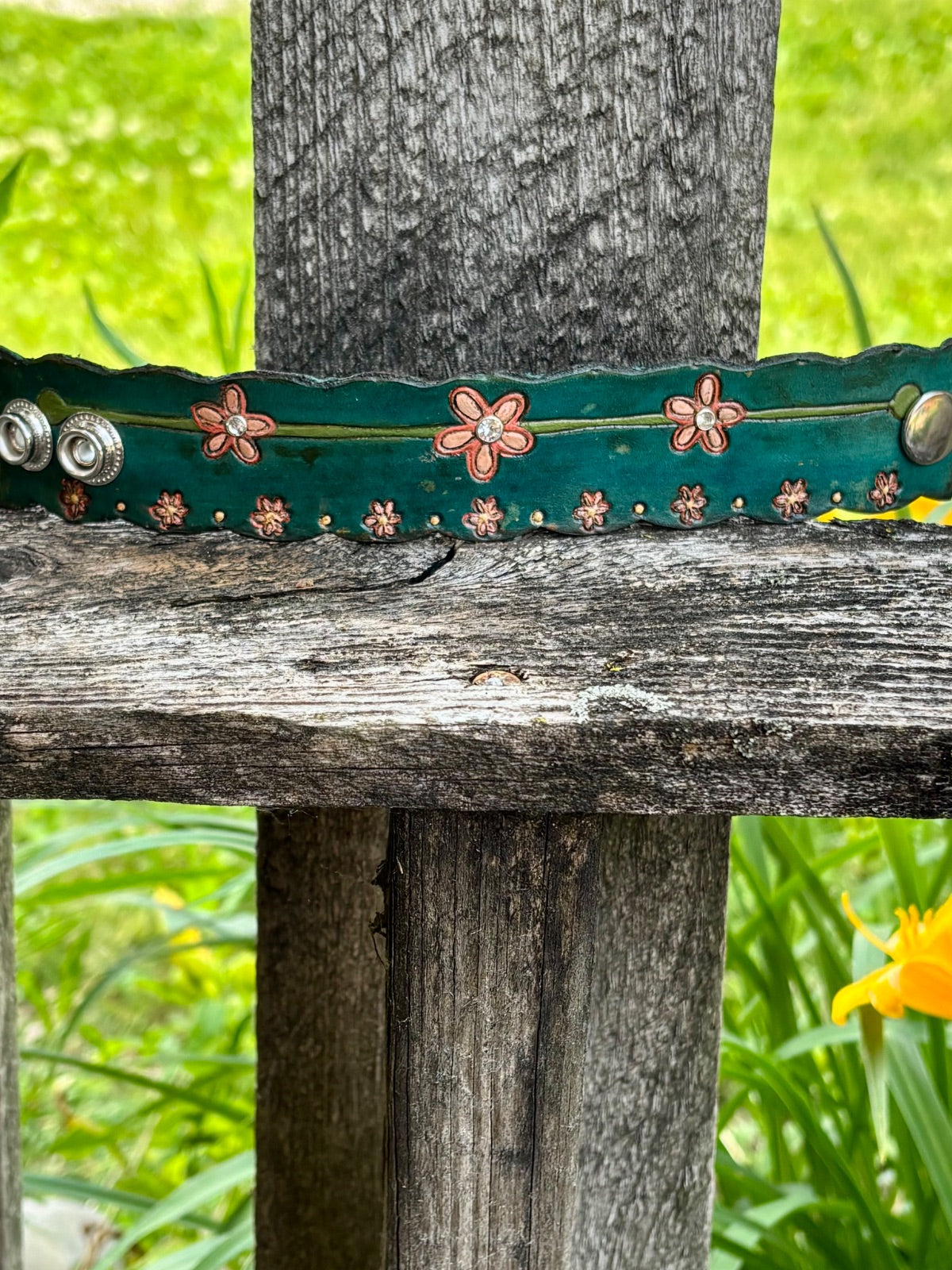 Teal leather cuff bracelet with hand-tooled coral flowers and rhinestone accents
