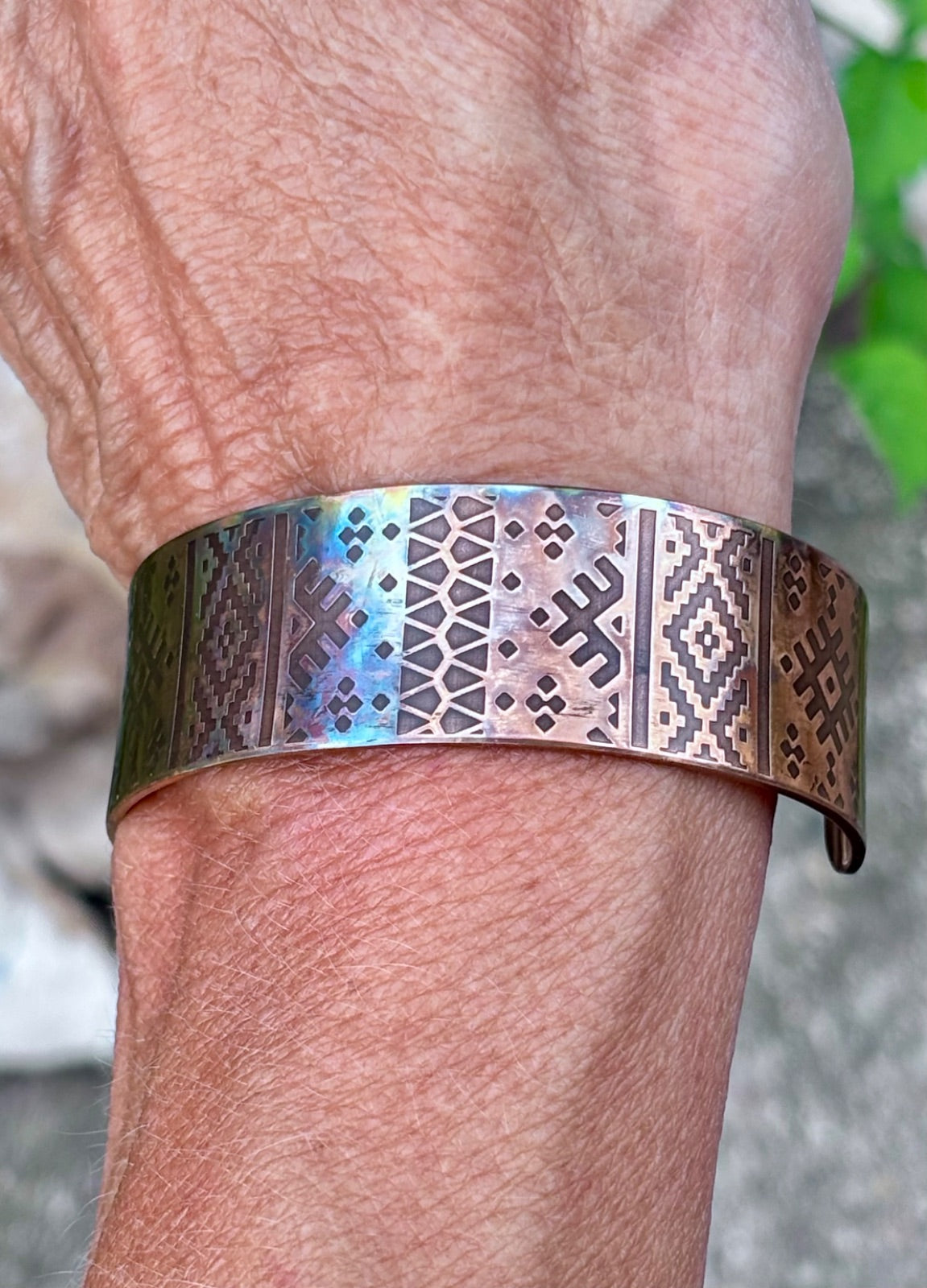 3/4 inch fire painted copper cuff bracelet worn on wrist