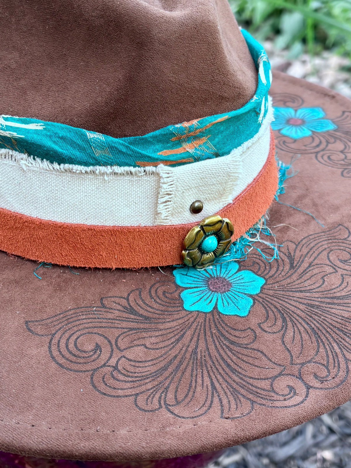 Layered hatband detail on turquoise flower rancher hat