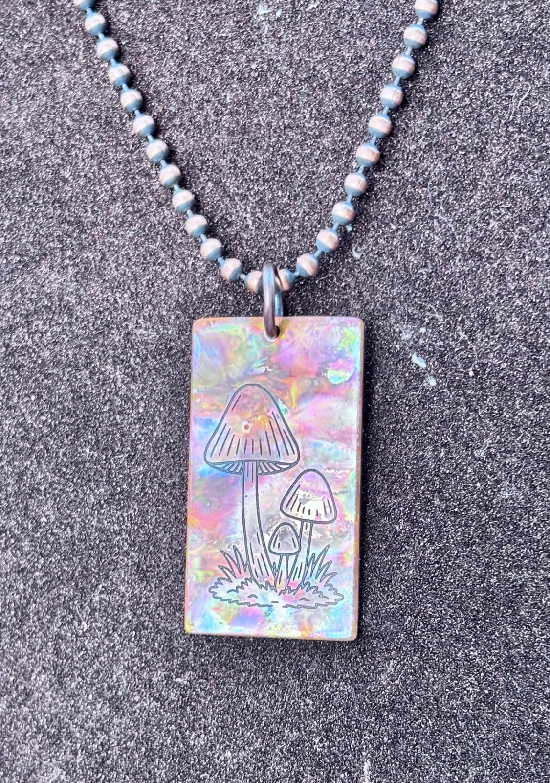 Fire painted copper necklace laid flat, full length view