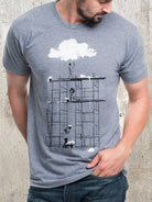 Man wearing heather gray Cloud Factory graphic tee with scaffolding and cloud illustration