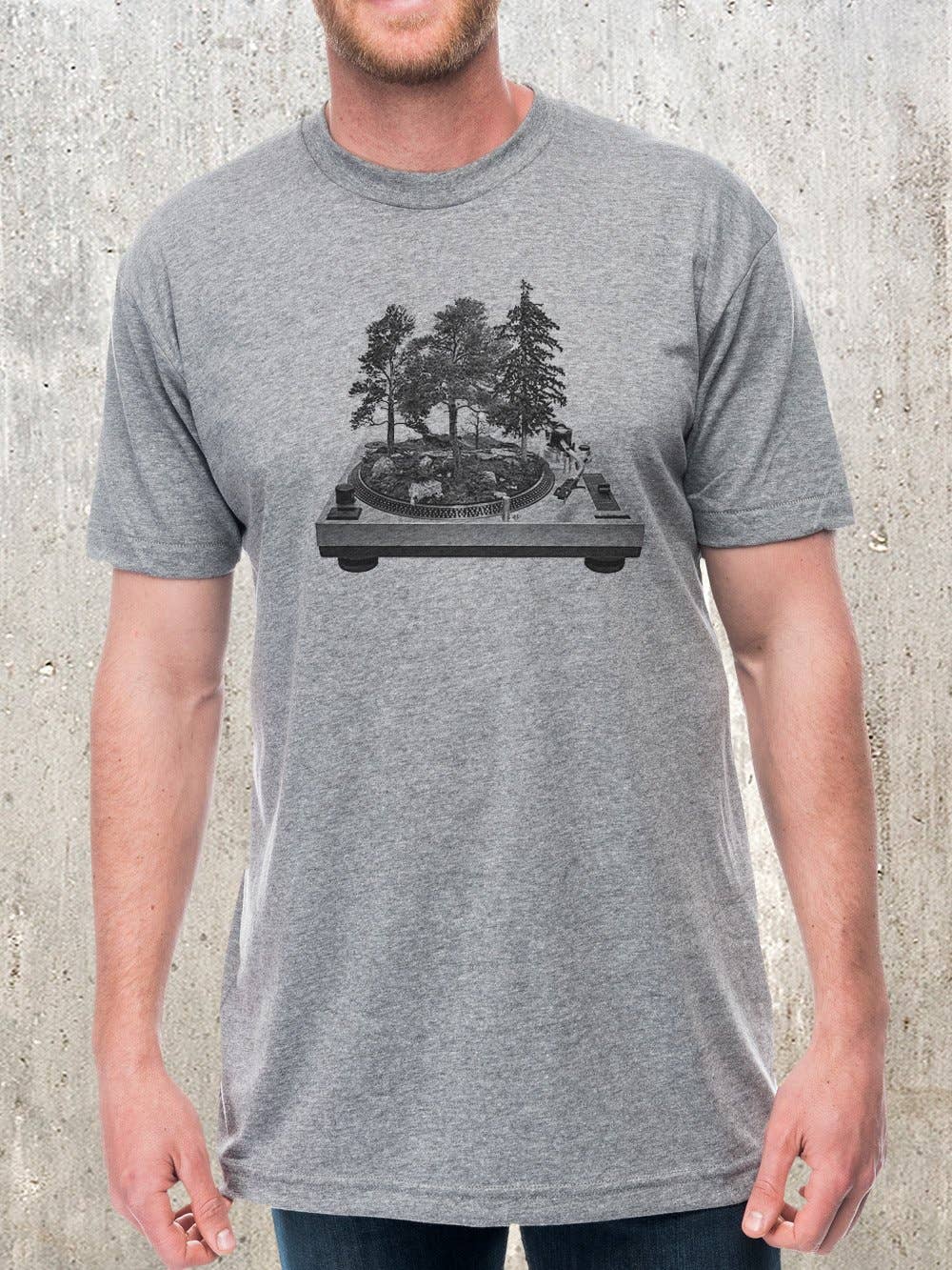 Man wearing heather gray Turntable Forest graphic tee with forest-on-vinyl illustration