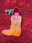 Hand-tooled leather cowboy boot bag charm with floral design