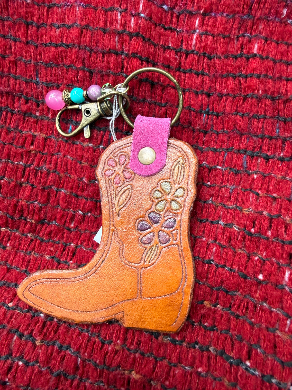 Hand-tooled leather cowboy boot bag charm with floral design