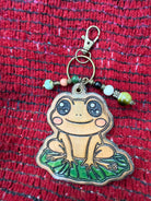 Hand-tooled leather frog bag charm on a lily pad