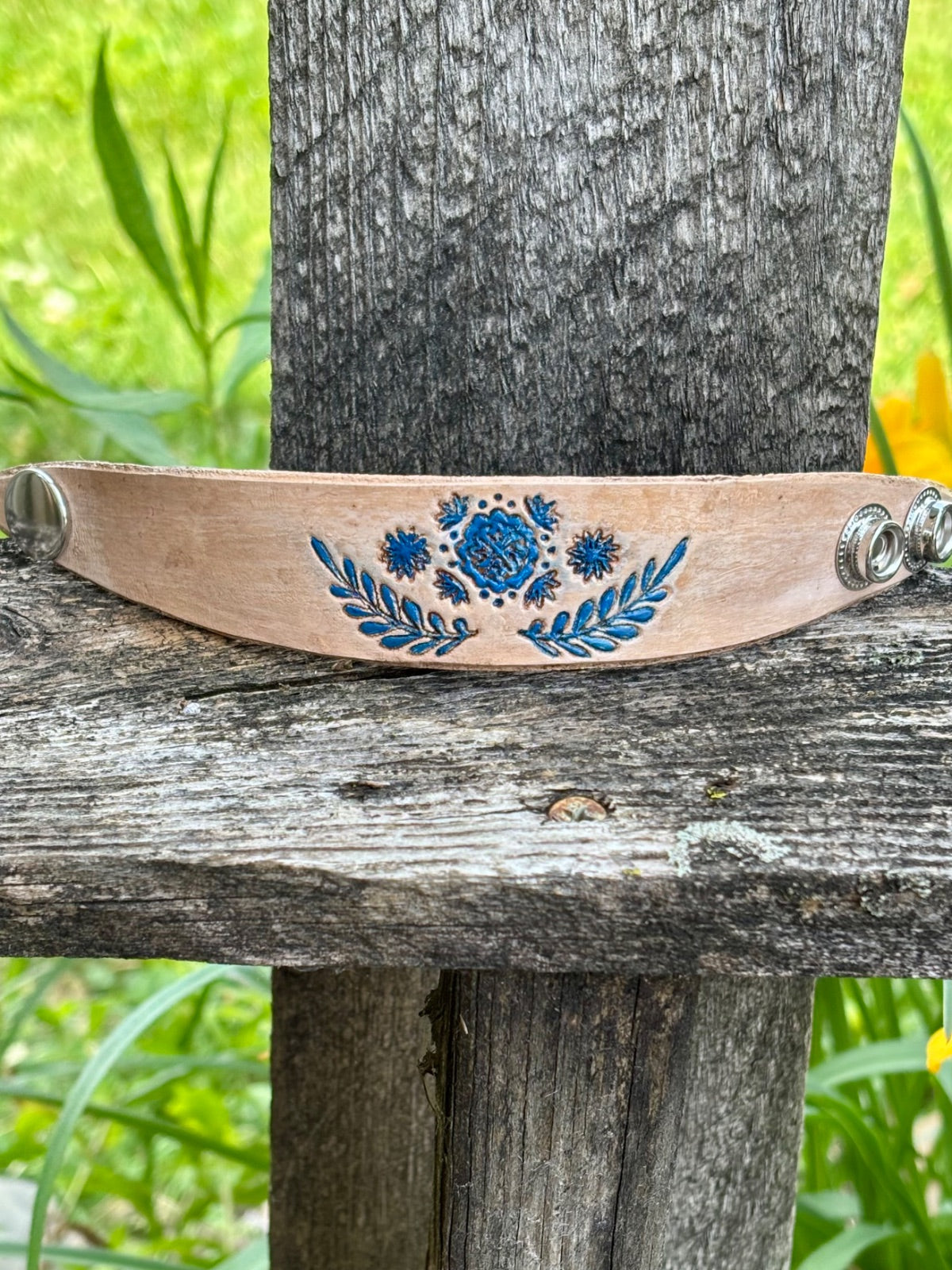 Natural leather cuff bracelet hand-tooled with blue floral design by Angie Meyers Designs