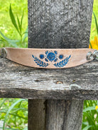Natural leather cuff bracelet hand-tooled with blue floral design by Angie Meyers Designs