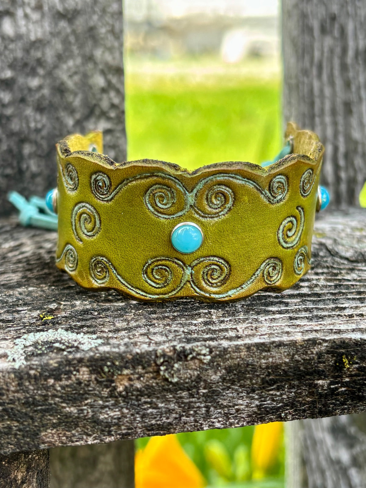 Olive green leather cuff bracelet with turquoise cabochons and swirl tooling by Angie Meyers Designs
