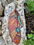 Large hand-tooled leather feather bag charm with turquoise beads and a suede tassel by Angie Meyers Designs
