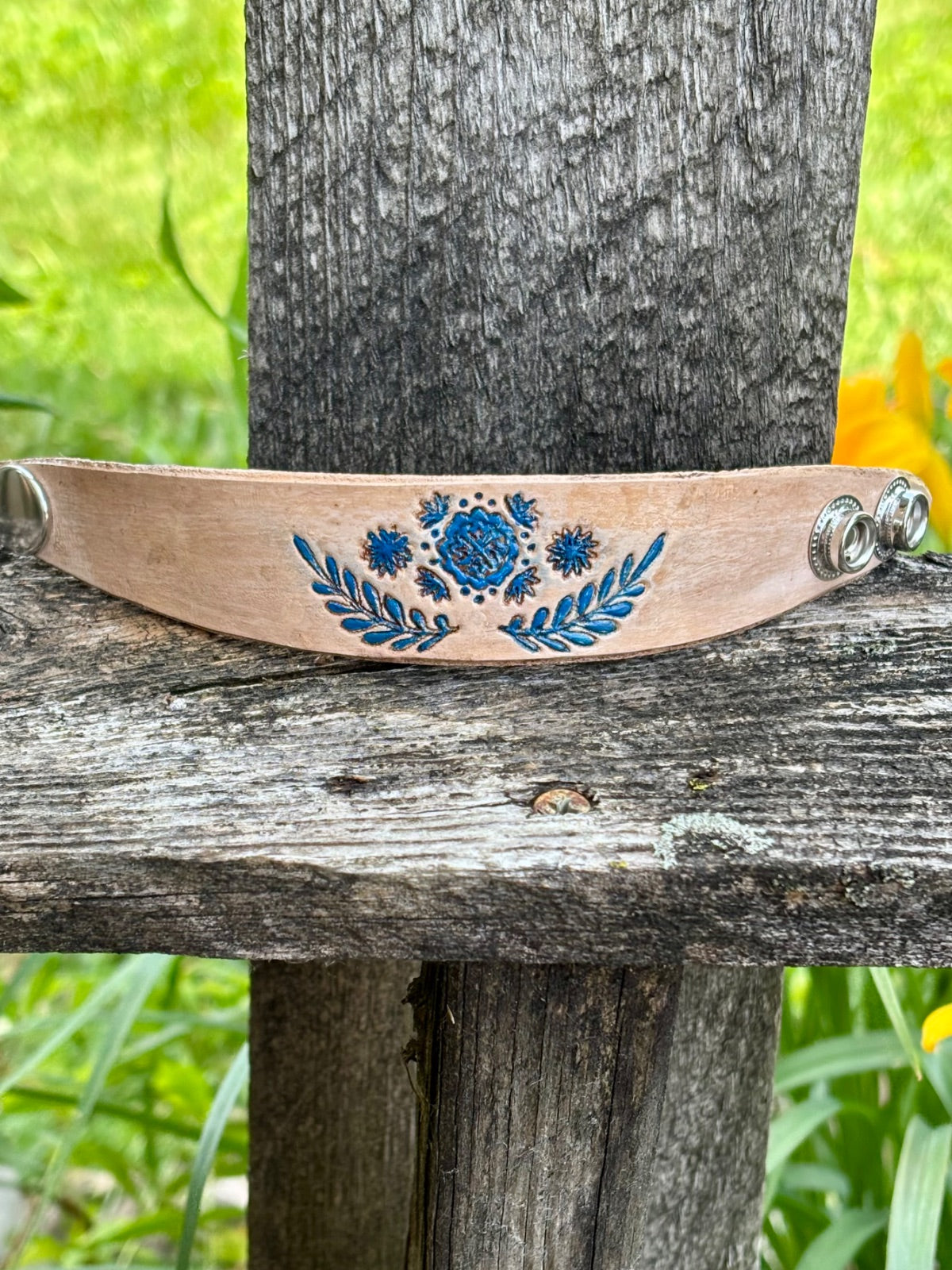 Blue floral leather cuff bracelet showing silver snap closure detail