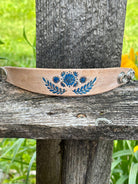 Blue floral leather cuff bracelet showing silver snap closure detail