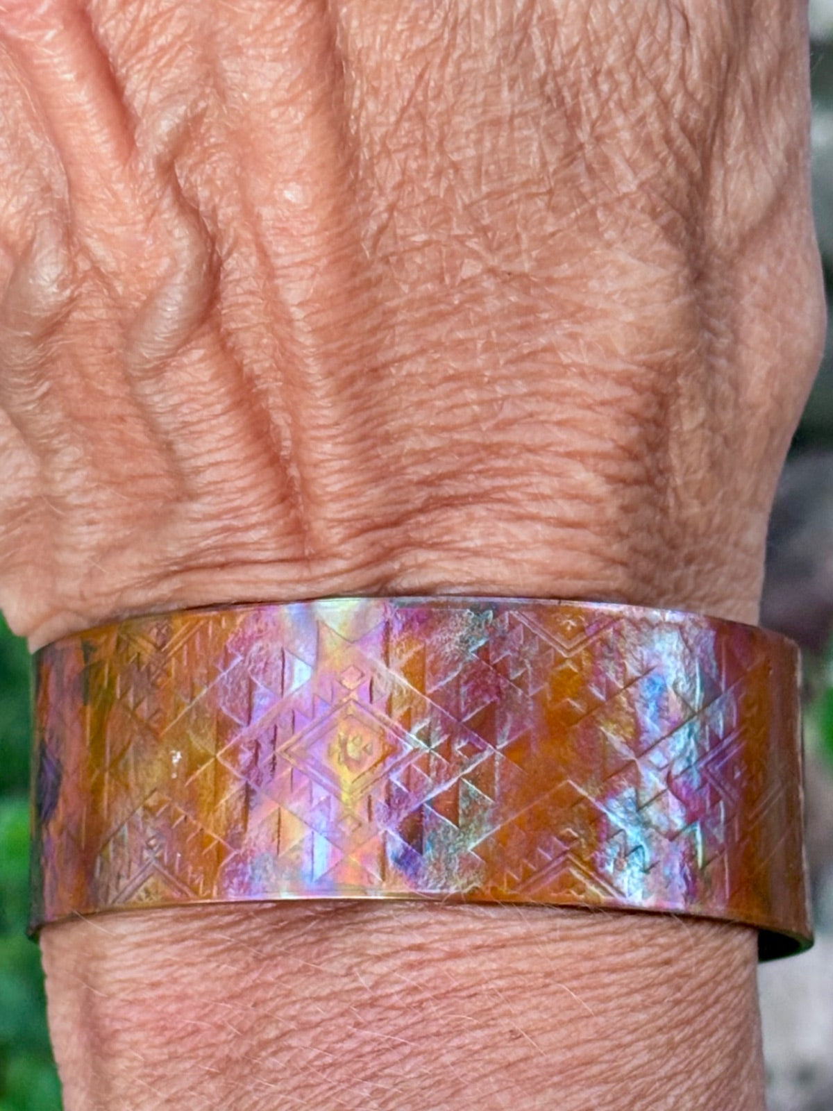 Close-up of fire-painted copper cuff bracelet texture