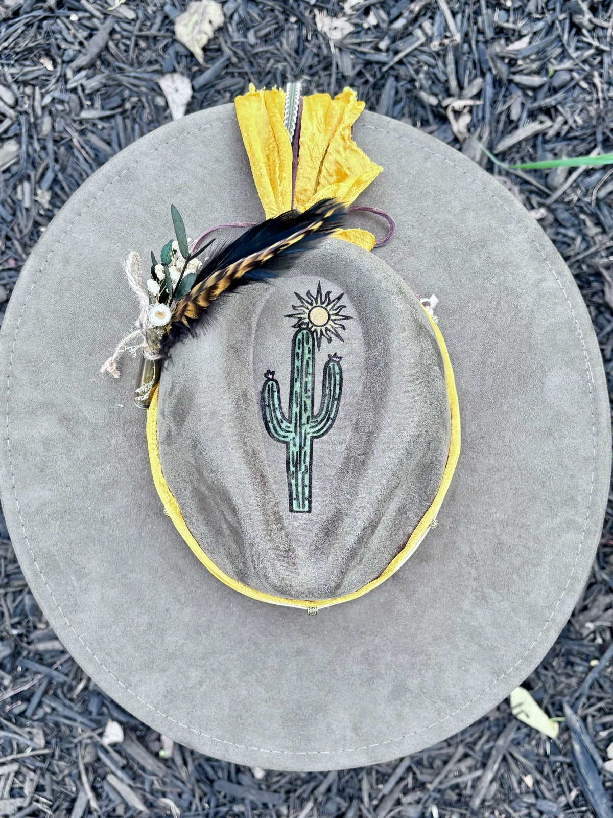 Close-up of hand-painted cactus design on rancher hat brim