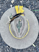 Close-up of hand-painted cactus design on rancher hat brim