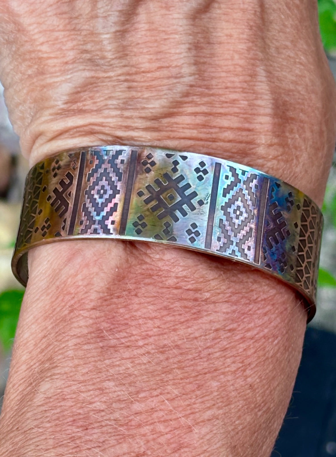 Close-up of fire-painted copper cuff bracelet texture