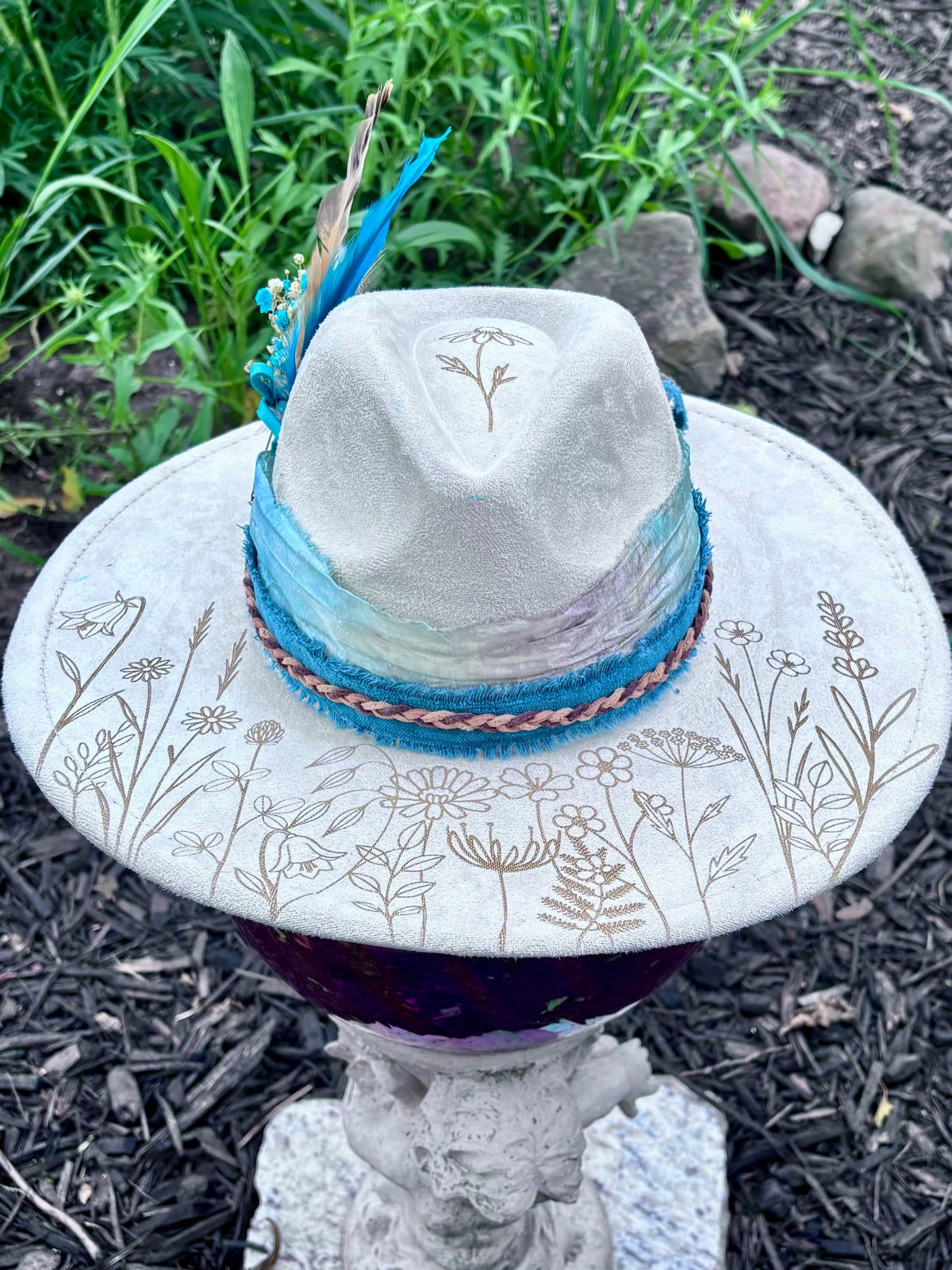 Close-up of laser-engraved dandelion design on rancher hat brim