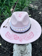 Side view of pink butterfly and feather vegan suede rancher hat