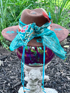 Side view of brown vegan suede rancher hat with turquoise flowers