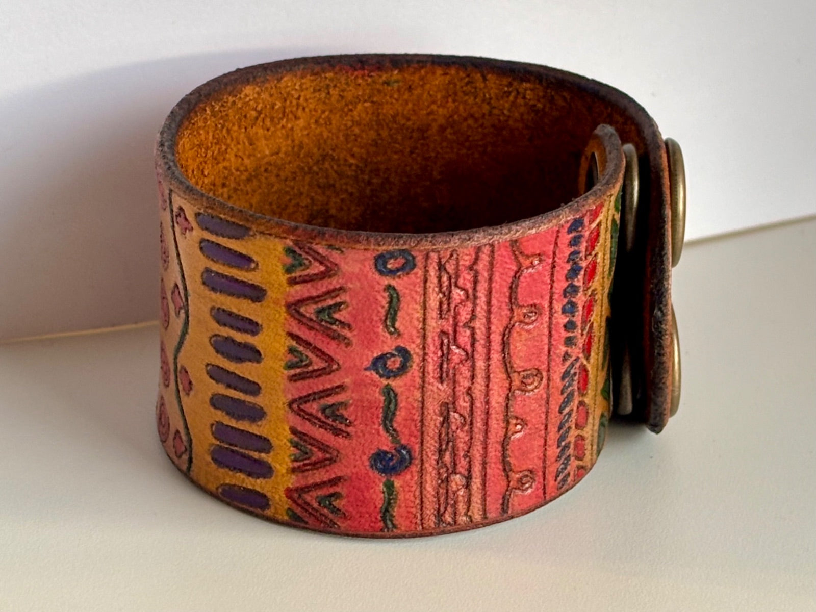 Wide tribal leather cuff bracelet side view showing tooled pattern detail