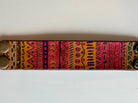 Wide tribal leather cuff bracelet laid flat showing full hand-painted pattern