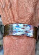 Side view of 3/4 inch fire painted copper cuff bracelet