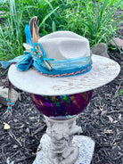 Bullet casing accent with feathers and dried florals on dandelion hat