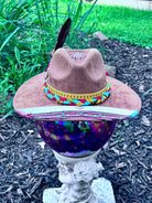 Bullet casing accent with feathers and dried florals on southwest aztec hat