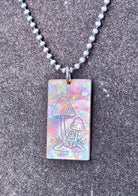 Fire painted copper necklace laid flat, full length view